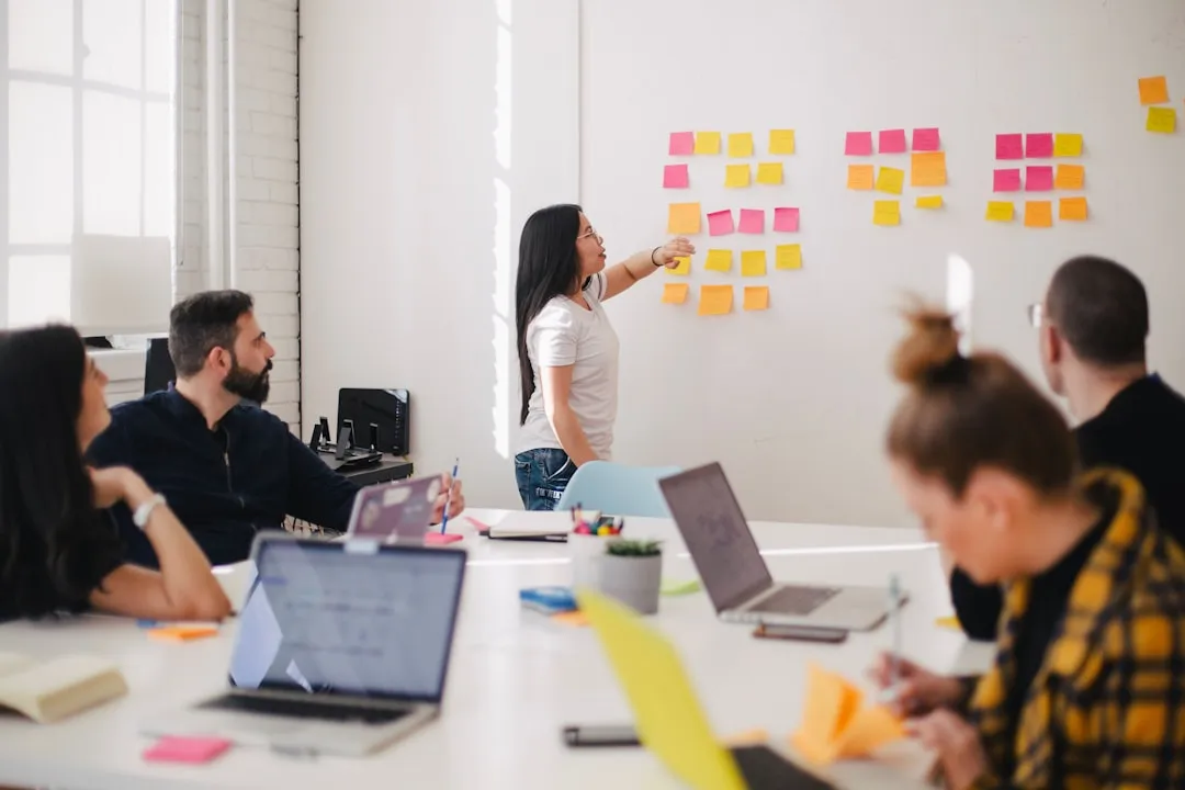 A diverse team analyzing data to optimize AI marketing campaigns on a large boardroom screen